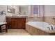 Bathroom vanity and soaking tub with tile surround at 412 Arbor Pointe Ave, Minneola, FL 34715
