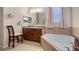 Bathroom with vanity, toilet, and soaking tub at 412 Arbor Pointe Ave, Minneola, FL 34715