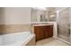 Bathroom with both shower and soaking tub, and vanity at 412 Arbor Pointe Ave, Minneola, FL 34715