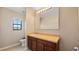 Bright bathroom with neutral tones, tile flooring, and a standard vanity at 412 Arbor Pointe Ave, Minneola, FL 34715