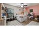 Charming bedroom with a stylish bed, a vanity table, a window with natural light and fun decor at 412 Arbor Pointe Ave, Minneola, FL 34715