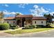 Clubhouse with stone arches and a tile roof surrounded by manicured landscaping and green lawns at 412 Arbor Pointe Ave, Minneola, FL 34715