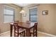 Bright dining room with a dark wood table illuminated by a modern pendant light at 412 Arbor Pointe Ave, Minneola, FL 34715
