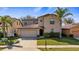 Two story home featuring an attached two car garage and well-manicured lawn at 412 Arbor Pointe Ave, Minneola, FL 34715