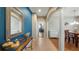 Inviting foyer with a tiled floor, bright blue accent wall, decorated console table and view to the living room at 412 Arbor Pointe Ave, Minneola, FL 34715