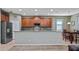 A well-appointed kitchen features stainless steel appliances, wood cabinets, and a stylish backsplash at 412 Arbor Pointe Ave, Minneola, FL 34715