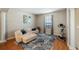 Cozy living area with a plush white sectional sofa, an exercise bike and a modern blue and grey area rug at 412 Arbor Pointe Ave, Minneola, FL 34715