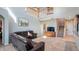 Bright living room with soaring ceilings, a leather sofa, and a view of the staircase at 412 Arbor Pointe Ave, Minneola, FL 34715