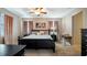 Spacious main bedroom with a ceiling fan, and ensuite bathroom at 412 Arbor Pointe Ave, Minneola, FL 34715