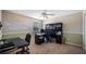 Functional office space with a large desk, black rolling chair, overhead lighting, and ample storage options at 412 Arbor Pointe Ave, Minneola, FL 34715