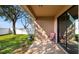 Outdoor patio with a chair, overlooking a landscaped yard with trees and a white fence at 412 Arbor Pointe Ave, Minneola, FL 34715