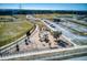 Aerial view of a fenced playground with play equipment, benches and nearby parking and baseball field at 412 Arbor Pointe Ave, Minneola, FL 34715