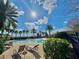 Inviting pool with lounge chairs on a brick patio with palm trees and blue skies creating a perfect relaxation spot at 412 Arbor Pointe Ave, Minneola, FL 34715