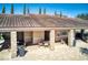 Pool house with stone pillars, tiled roof and plenty of shaded seating next to an outdoor trash receptacle at 412 Arbor Pointe Ave, Minneola, FL 34715