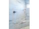 The updated shower features marble-look tile, a seat and an adjustable shower head at 4658 Hiles Pl, The Villages, FL 32163