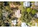 Overhead view of charming house on lot surrounded by green trees and other homes at 4723 Cr 306, Lake Panasoffkee, FL 33538