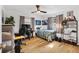 Bedroom with hardwood floors, desk, and ceiling fan at 4723 Cr 306, Lake Panasoffkee, FL 33538