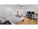 Bright bedroom with hardwood floors, ensuite bathroom access, and desk at 4723 Cr 306, Lake Panasoffkee, FL 33538