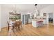 Bright dining area and kitchen with stainless steel appliances, hardwood floors, and modern lighting at 4723 Cr 306, Lake Panasoffkee, FL 33538
