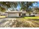 Charming single-story home with a two-car garage and inviting front yard at 4723 Cr 306, Lake Panasoffkee, FL 33538