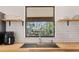 Modern kitchen sink with subway tile backsplash and butcher block countertops at 4723 Cr 306, Lake Panasoffkee, FL 33538