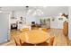 Open-concept living space with a butcher block island, dining table, and comfortable seating at 4723 Cr 306, Lake Panasoffkee, FL 33538