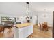 Open-concept living space with a butcher block island, dining table, and comfortable seating at 4723 Cr 306, Lake Panasoffkee, FL 33538