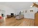 Bright living room featuring wood floors, cozy seating, and ample natural light at 4723 Cr 306, Lake Panasoffkee, FL 33538