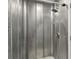 Unique shower with metal-paneled walls and a modern showerhead at 4723 Cr 306, Lake Panasoffkee, FL 33538
