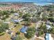 Aerial view of the home, showcasing its location within a residential neighborhood with nearby lakes at 4918 County Road 114, Wildwood, FL 34785
