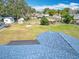 Aerial view of the home showcasing its blue roof, expansive backyard, and neighborhood setting at 4918 County Road 114, Wildwood, FL 34785