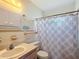 Cozy bathroom featuring a bathtub, patterned shower curtain, and single-sink vanity at 4918 County Road 114, Wildwood, FL 34785