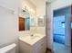 Bathroom with white vanity, decorative mirror, and tiled floors at 4918 County Road 114, Wildwood, FL 34785