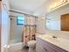 Well-lit bathroom with shower-tub combo and stylish vanity at 4918 County Road 114, Wildwood, FL 34785