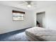 Bright bedroom with large window, ceiling fan, and closet at 4918 County Road 114, Wildwood, FL 34785