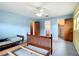 Comfortable bedroom featuring a ceiling fan and easy access to an attached bathroom at 4918 County Road 114, Wildwood, FL 34785