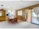 The dining room has paneled accents, tile floors and a sliding glass door to the backyard at 4918 County Road 114, Wildwood, FL 34785