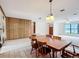 Open dining area showcasing the original wood paneled walls and a connecting living space at 4918 County Road 114, Wildwood, FL 34785