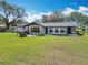 Charming single-story home with a spacious front yard and mature trees at 4918 County Road 114, Wildwood, FL 34785