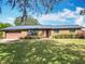 Charming single story brick home with a well-maintained front yard and beautiful landscape at 4918 County Road 114, Wildwood, FL 34785