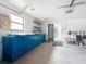 Well-lit garage featuring a blue workbench, overhead storage, and access to the interior at 4918 County Road 114, Wildwood, FL 34785
