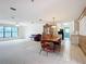 Spacious living room with tile flooring, large windows, and an adjoining dining area with wood accents at 4918 County Road 114, Wildwood, FL 34785