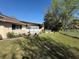 Spacious backyard featuring well-kept lawn, screened patio, and fenced yard for outdoor enjoyment at 5 Magnolia Ln, Yalaha, FL 34797