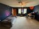 Comfortable bedroom with carpet, space-themed decor, a ceiling fan, and computer desk at 5 Magnolia Ln, Yalaha, FL 34797