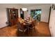 Cozy dining room with a chandelier and a decorative glass window with nature scene at 5 Magnolia Ln, Yalaha, FL 34797