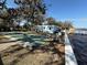 Community shuffleboard court near the water with inviting benches, perfect for outdoor recreation and relaxation at 5 Magnolia Ln, Yalaha, FL 34797