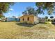 Rear view of the house featuring the backyard and a small patio at 520 Saint Andrews Blvd, The Villages, FL 32159