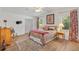 Cozy bedroom with comfortable bed, side tables, and stylish curtains, and a ceiling fan at 520 Saint Andrews Blvd, The Villages, FL 32159