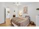 Well-lit bedroom featuring a ceiling fan, wood floors, and tasteful decorations at 520 Saint Andrews Blvd, The Villages, FL 32159