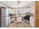 Well-equipped kitchen with stainless steel appliances, white cabinetry, and plenty of natural light at 520 Saint Andrews Blvd, The Villages, FL 32159